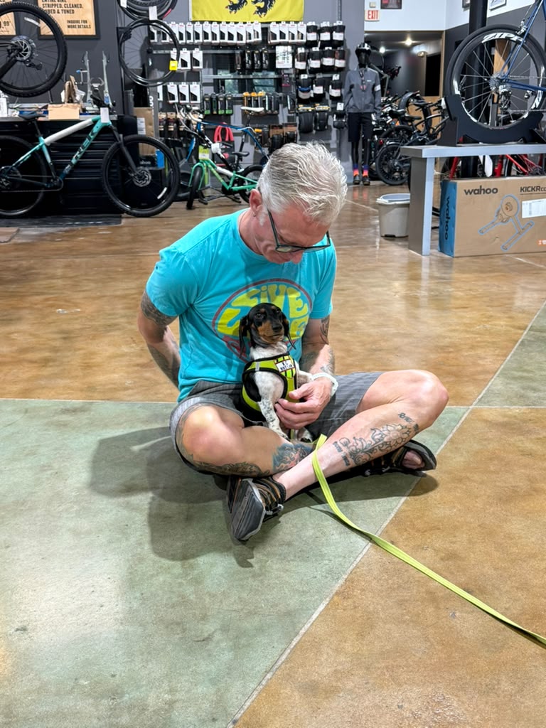 Coach Roger Williams holding KC Bike Law mascot Gretchen during the legal rights session at Trek Bicycle Shawnee
